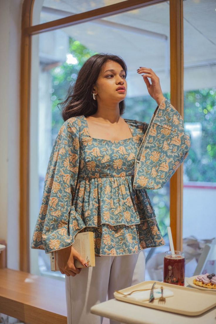 Blue floral peplum kurti top for women with bell sleeves and layered design, stylish ethnic wear