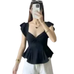 woman wearing black ruched peplum top with cap sleeves paired with white pants stylish korean fashion outfit
